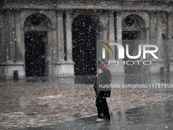 A man walks in the courtyard of the Louvre Museum in heavy snowfall as Paris is under the second highest weather warning by the French natio...