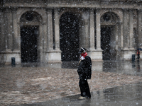 A man walks in the courtyard of the Louvre Museum in heavy snowfall as Paris is under the second highest weather warning by the French natio...