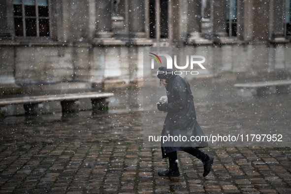 A woman walks in the courtyard of the Louvre Museum in heavy snowfall as Paris is under the second highest weather warning by the French nat...