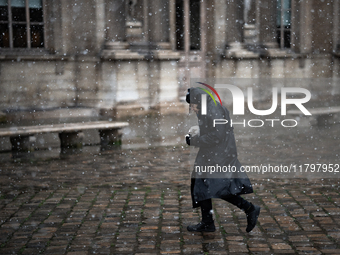 A woman walks in the courtyard of the Louvre Museum in heavy snowfall as Paris is under the second highest weather warning by the French nat...