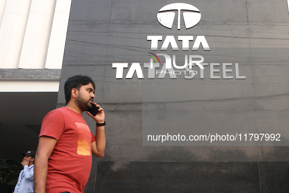 A man talks on a mobile phone in front of a Tata Steel logo in Kolkata, India, on November 21, 2024. Tata Steel's last traded price is 140.2...