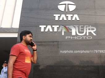 A man talks on a mobile phone in front of a Tata Steel logo in Kolkata, India, on November 21, 2024. Tata Steel's last traded price is 140.2...