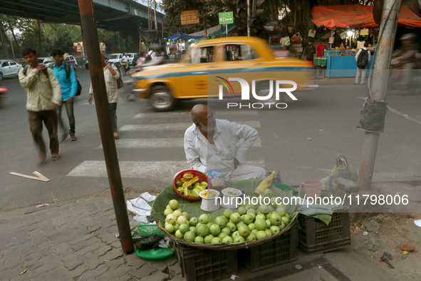 A fruit shaker waits for customers in Kolkata, India, on November 21, 2024. 