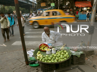 A fruit shaker waits for customers in Kolkata, India, on November 21, 2024. (