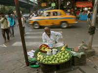 A fruit shaker waits for customers in Kolkata, India, on November 21, 2024. (