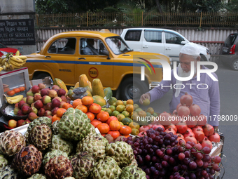 A fruit shaker waits for customers in Kolkata, India, on November 21, 2024. (