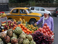 A fruit shaker waits for customers in Kolkata, India, on November 21, 2024. (