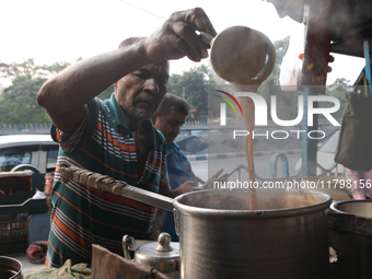 A tea seller makes tea at a street-side temporary tea stall in Kolkata, India, on November 21, 2024. (