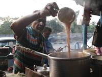 A tea seller makes tea at a street-side temporary tea stall in Kolkata, India, on November 21, 2024. (