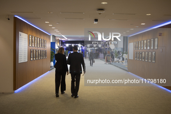 In Belgium, in the corridor to Parliament offices, on November 20, 2024, delegates and visitors walk through a sleek, modern hallway lined w...