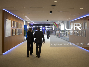 In Belgium, in the corridor to Parliament offices, on November 20, 2024, delegates and visitors walk through a sleek, modern hallway lined w...