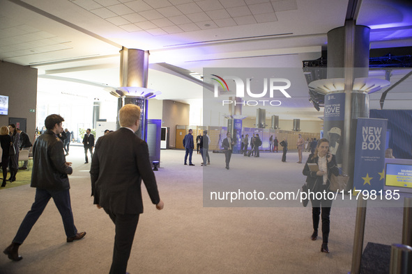 In Belgium, in the corridor to Parliament offices, on November 20, 2024, delegates and visitors walk through a sleek, modern hallway lined w...