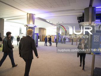 In Belgium, in the corridor to Parliament offices, on November 20, 2024, delegates and visitors walk through a sleek, modern hallway lined w...