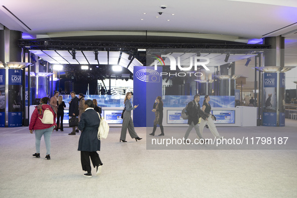 In Belgium, in the corridor to Parliament offices, on November 20, 2024, delegates and visitors walk through a sleek, modern hallway lined w...