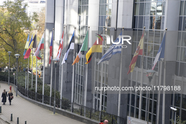 The flags of all EU member states fly outside the European Parliament building in Brussels, Belgium, on November 20, 2024, symbolizing unity...