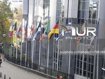 The flags of all EU member states fly outside the European Parliament building in Brussels, Belgium, on November 20, 2024, symbolizing unity...