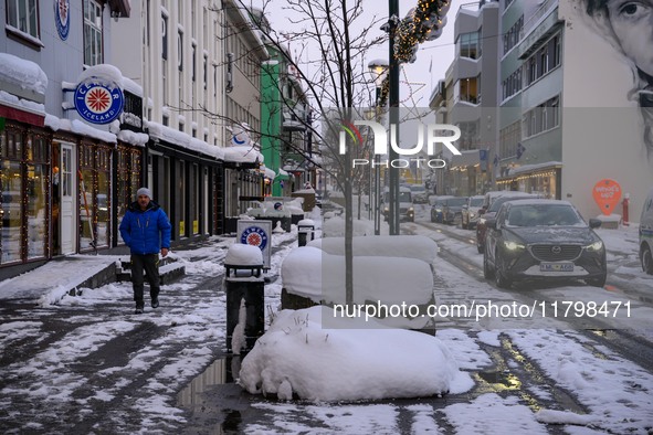 A person walks down a street in Akureyri, Iceland, on November 19, 2024. 