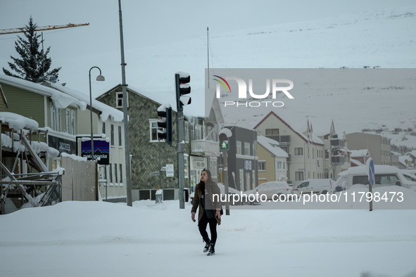 A person walks down a street in Akureyri, Iceland, on November 19, 2024. 