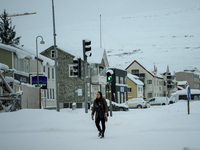 A person walks down a street in Akureyri, Iceland, on November 19, 2024. (