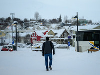 A person walks down a street in Akureyri, Iceland, on November 19, 2024. (