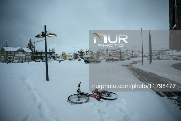 A bicycle is on the ground in a park in Akureyri, Iceland, on November 20, 2024. 