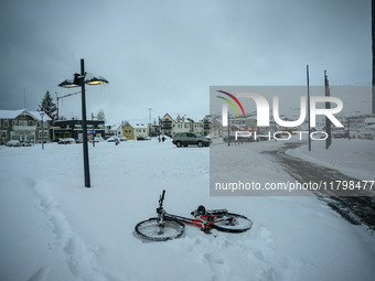 A bicycle is on the ground in a park in Akureyri, Iceland, on November 20, 2024. (