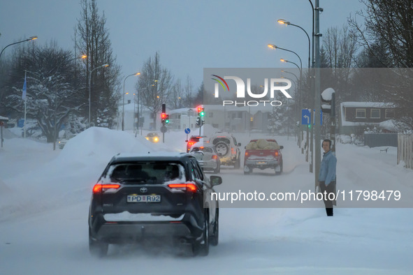 Several cars drive along one of the main streets in Akureyri, Iceland, on November 20, 2024. 