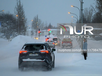 Several cars drive along one of the main streets in Akureyri, Iceland, on November 20, 2024. (