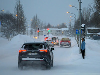 Several cars drive along one of the main streets in Akureyri, Iceland, on November 20, 2024. (