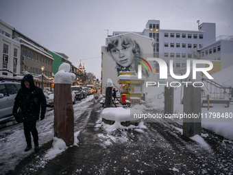 A person walks down a street in Akureyri, Iceland, on November 19, 2024. (