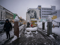 A person walks down a street in Akureyri, Iceland, on November 19, 2024. (