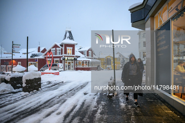 A person walks down a street in Akureyri, Iceland, on November 19, 2024. 