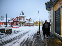 A person walks down a street in Akureyri, Iceland, on November 19, 2024. (