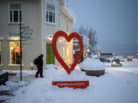 A person walks down a street in Akureyri, Iceland, on November 19, 2024. (