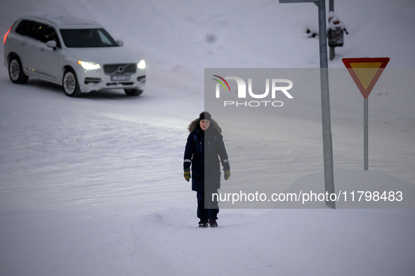 A person walks down a street in Akureyri, Iceland, on November 19, 2024. 