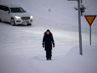 A person walks down a street in Akureyri, Iceland, on November 19, 2024. (