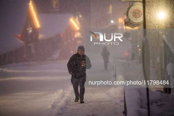 A person walks down a street in Akureyri, Iceland, on November 19, 2024. 