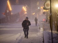 A person walks down a street in Akureyri, Iceland, on November 19, 2024. (