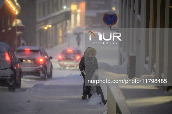 A person walks down a street in Akureyri, Iceland, on November 19, 2024. 