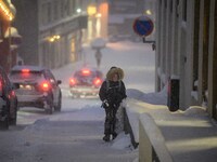 A person walks down a street in Akureyri, Iceland, on November 19, 2024. (