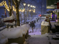 A person walks down a street in Akureyri, Iceland, on November 19, 2024. (