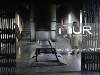 Tumpa Das, age 29, walks before the cremation of a dead body in a furnace inside a crematorium at Baruipur Panchayat area in South 24-Pargan...