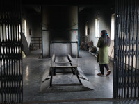 Tumpa Das, age 29, walks before the cremation of a dead body in a furnace inside a crematorium at Baruipur Panchayat area in South 24-Pargan...