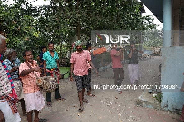 Relatives carry a dead body after performing rituals before cremation in a furnace inside a crematorium at Baruipur Panchayat area in South...