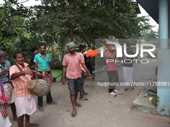 Relatives carry a dead body after performing rituals before cremation in a furnace inside a crematorium at Baruipur Panchayat area in South...