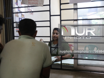 Tumpa Das, age 29, a woman Dom, speaks with relatives before preparing a death certificate during the cremation of a dead body in a furnace...