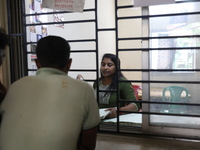 Tumpa Das, age 29, a woman Dom, speaks with relatives before preparing a death certificate during the cremation of a dead body in a furnace...