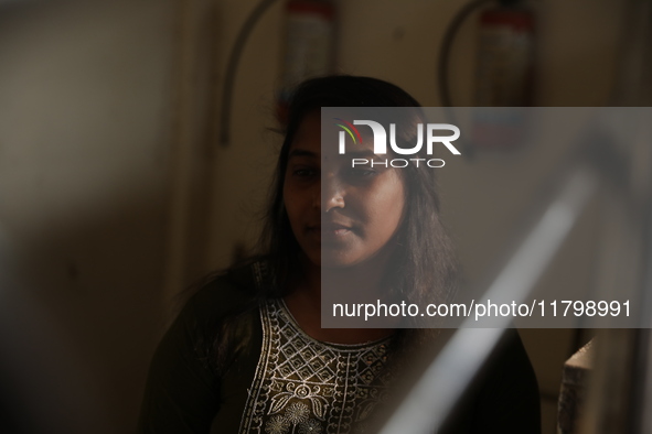 Tumpa Das, age 29, waits before the cremation of a dead body in a furnace in a crematorium in the Baruipur Panchayat area in South 24-Pargan...