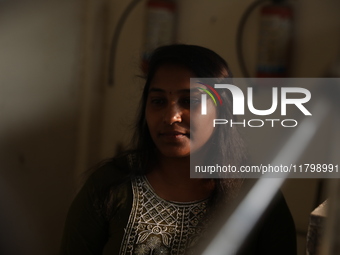 Tumpa Das, age 29, waits before the cremation of a dead body in a furnace in a crematorium in the Baruipur Panchayat area in South 24-Pargan...