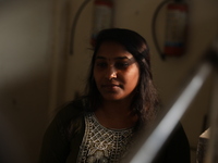 Tumpa Das, age 29, waits before the cremation of a dead body in a furnace in a crematorium in the Baruipur Panchayat area in South 24-Pargan...